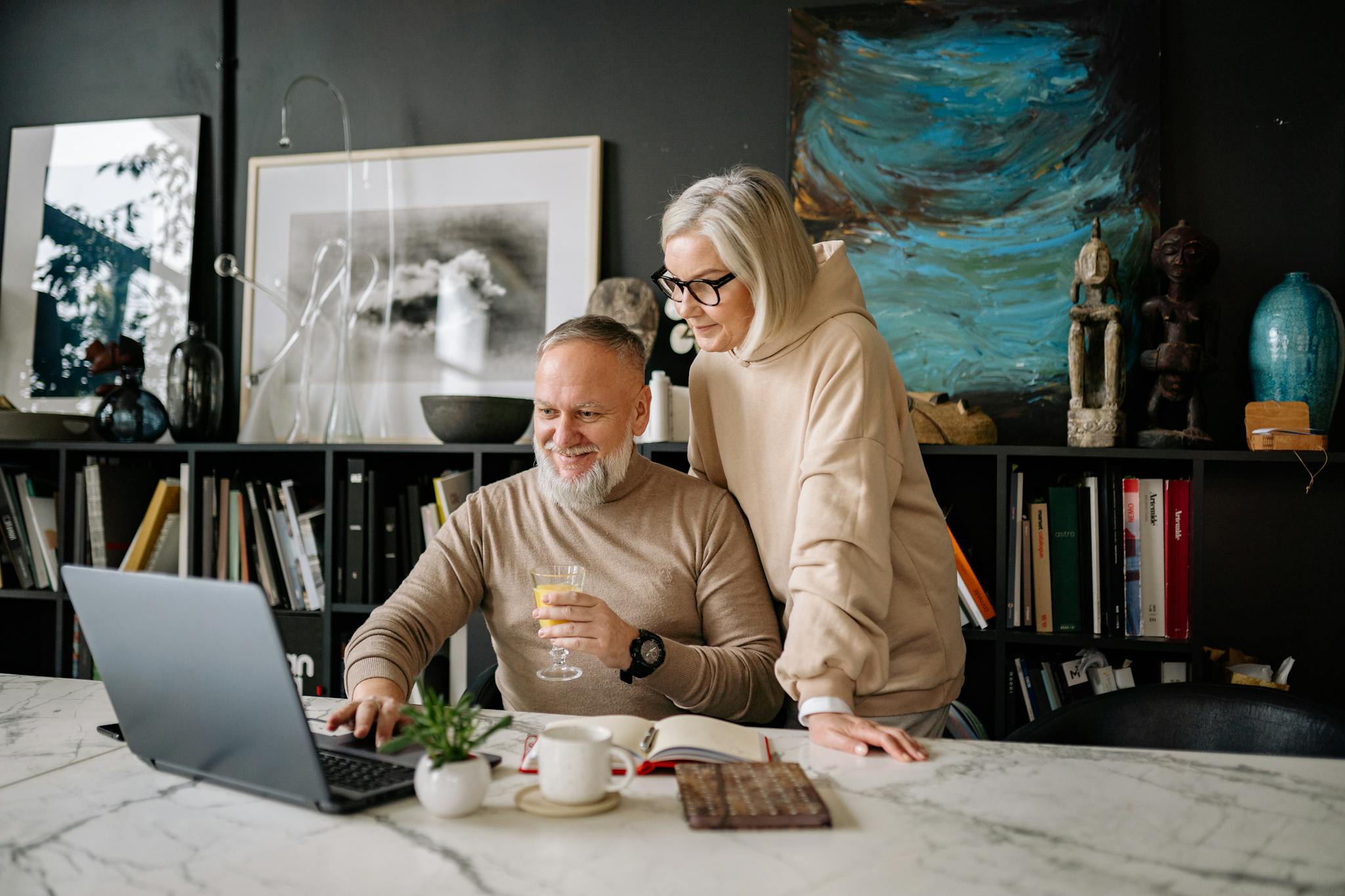 elderly couple using a laptop at home enjoying online activities and companionship. 6818102 elderly couple using a laptop at home enjoying online activities and companionship. 6818102