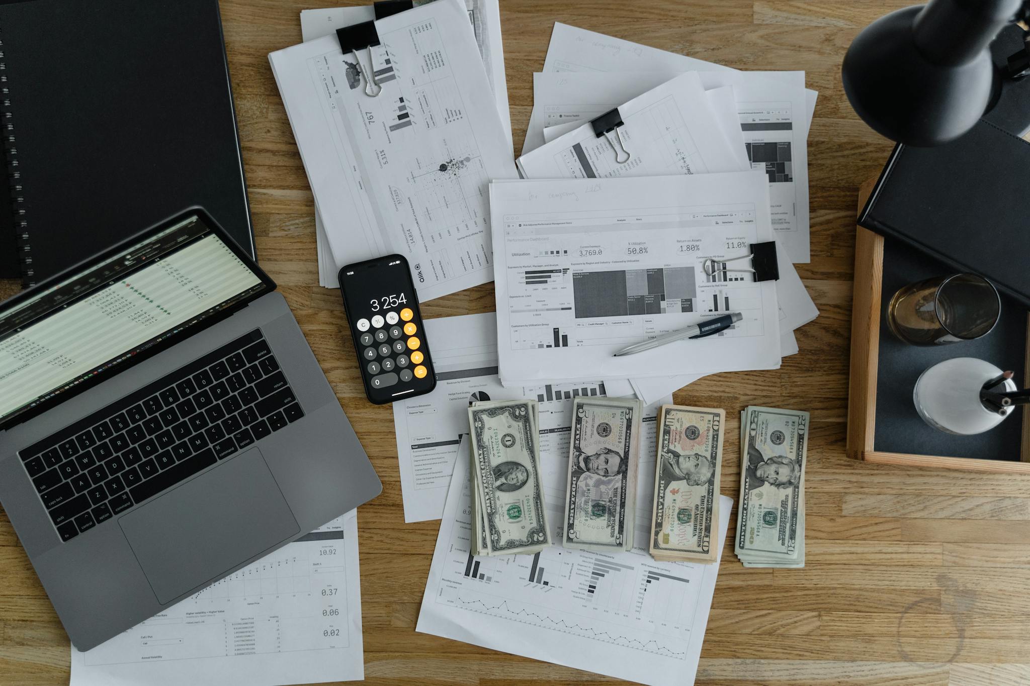 overhead view of financial documents cash and technology on a wooden desk. 6693655 Foundation Template Title